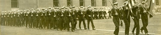 Midshipmen in the Naval Reserve Officers' Training Corps program pass in review just south of College Walk. Midshipmen in the Naval Reserve Officers' Training Corps program pass in review just south of College Walk.