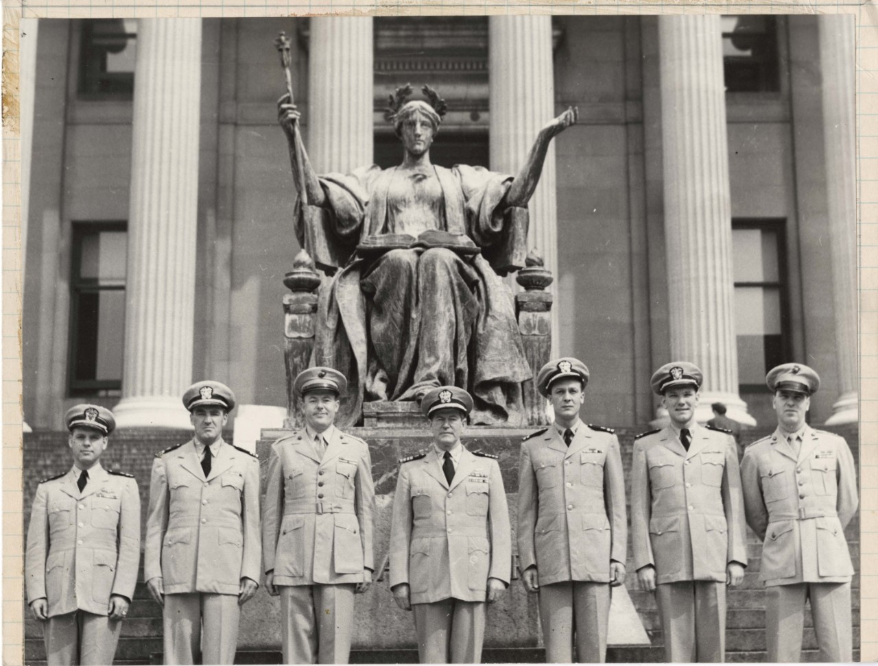 Seven NROTC officers posing in front of Alma Mater statue, 1953 Columbian